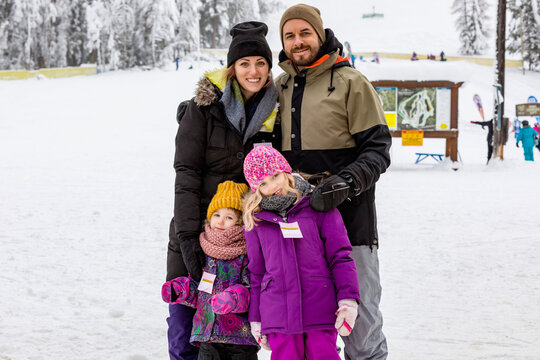 Parents and their children posing for a picture while vacationing at a ski resort; Fairmont Hot Springs, British Columbia, Canada