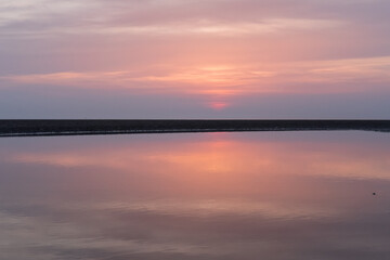 A vivid deep purple and pink los angeles sunset. Beautiful vibrant saturated dreamy sky and colours. Deep pink hues sunset with soft light and clouds.