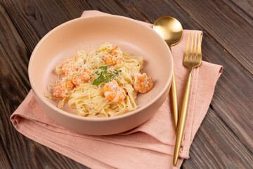Pasta al dente with shrimp in cream sauce with cheese, open space