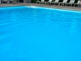 Fototapeta na wymiar Outdoor swimming pool in luxury hotel on sunny summer day. Time for relax