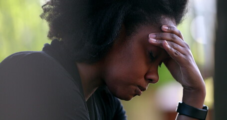 Frustrated Black woman shaking head in regret