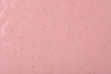 Tasty pink smoothie with bubbles as background, closeup