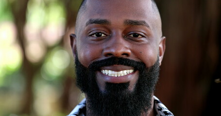 Friendly African man smiling at camera portrait, handsome black person