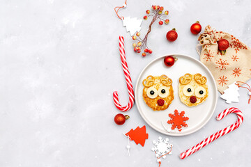 Christmas deers face pancake with raspberry for kids baby children breakfast dinner. xmas food