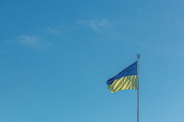 Ukrainian flag against the blue sky