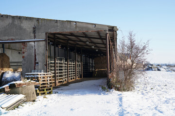 An old and abandoned building with stables.