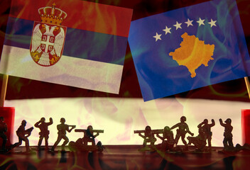 Soldiers on the battlefield against the flags of the countries Serbia, Kosovo concept of war crisis...