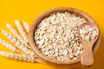 Rolled oats, uncooked oatmeal in bowl. Diet food for weight loss, healthy lifestyle