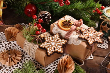 Christmas gifts wrapped in brown paper with gingerbread cookie decor
