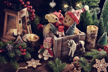 Christmas still life with old teddy bears in wooden box on the table in rustic style with faded...