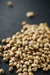 natural hemp seed on black stone background