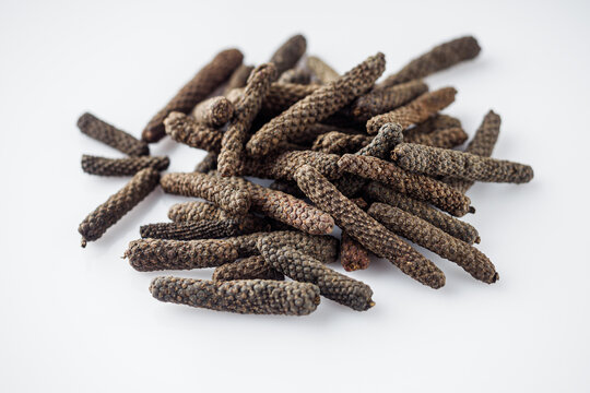 dried aromatic pippali long pepper on a white background