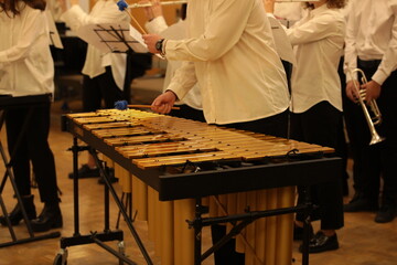 Youth jazz band in white clothes playing music in the school orchestra