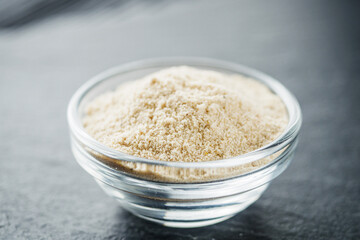 asafoetida aromatic powder on a black stone background
