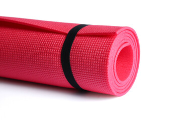 A pink yoga mat isolated on a white background. Сoncept of fitness equipment.