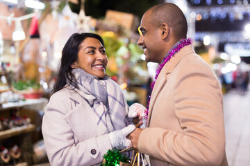 Portrait of happy couple in love at christmas street fair