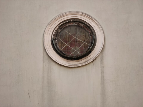 Small Round Window On White Wall. Close-up.