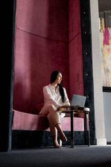 Beautiful fashion business woman planning analyzing work taking notes elegant notepad at luxury room