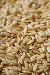 raw unpolished rice on a white acrylic background