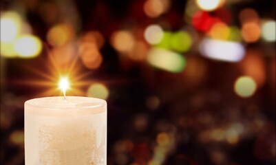Classic candle with bright light on dark background