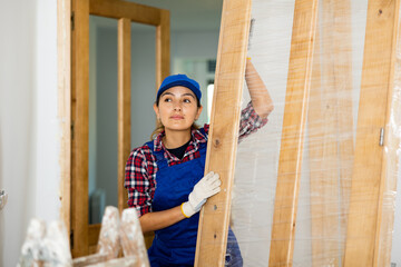 Portrait of female professional door installer in a renovated room