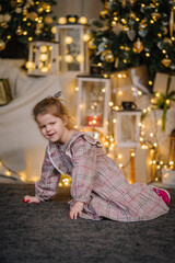 A young girl lives in Christmas decorations