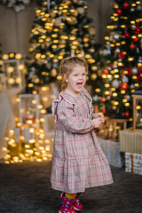Fototapeta na wymiar A young girl lives in Christmas decorations