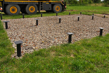 Metal screw piles. Prepared foundation for a modular home.
