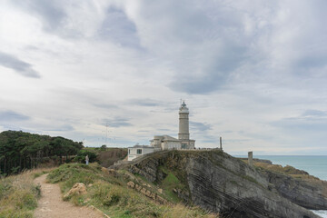 Fototapeta na wymiar Fantastic cloudscape of the Cabo Mayor lighthouse in Santander, Spain