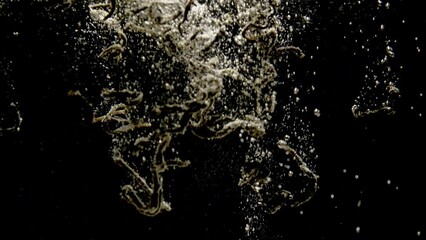 Background slow motion video of tea leaves being thrown into boiling water. Brewing and tea ceremony. High quality 4k footage