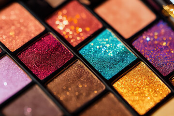 Detailed image of makeup palette, many colors and glitter.