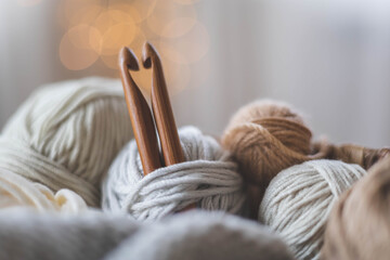 Cozy homely atmosphere. Heart from hooks for knitting. Yarn in neutral colors.
