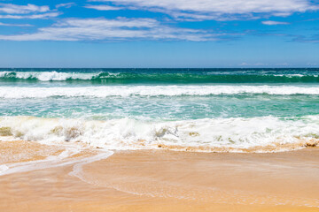 Fototapeta na wymiar Sand and waves in Quatro Ilhas beach