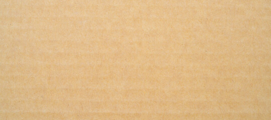 smooth brown cardboard paper, full frame, close up. background and texture of brown paper corrugated sheet board surface