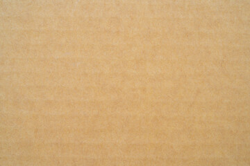 smooth brown cardboard paper, full frame, close up. background and texture of brown paper corrugated sheet board surface