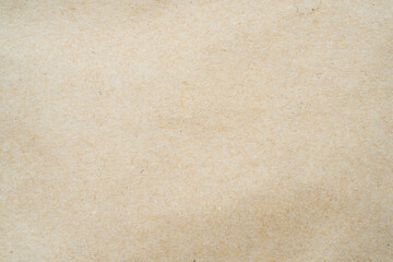 smooth brown cardboard paper, full frame, close up. background and texture of brown paper corrugated sheet board surface