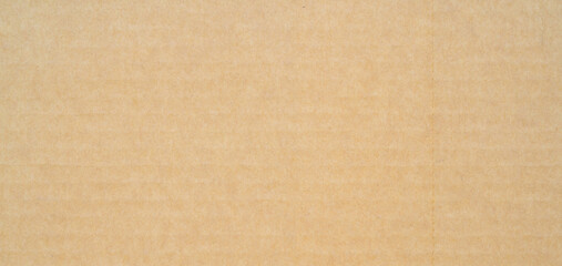 smooth brown cardboard paper, full frame, close up. background and texture of brown paper corrugated sheet board surface