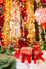 Christmas gift boxes with red ribbon on bokeh blur lights and illumination background