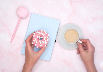  the girl calculates in a notebook the calories of a donut and a cup of coffee