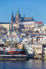 Snowy Prague Lesser Town with Prague Castle above River Vltava in the sunny Day , Czech republic