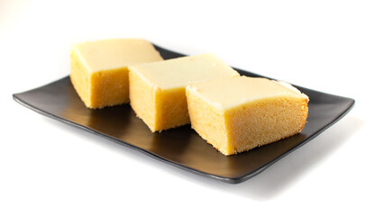 plate with pieces of lemon brownie dessert cake isolated on a white background