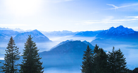 Swiss Alps Mount Pilatus towering over foggy misty Vierwaldstattersee, Lake Lucern, Rigi, Switzerland
