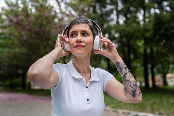 one woman mature senior prepare for guided meditation with headphones
