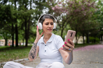 one woman mature senior prepare for guided meditation with headphones