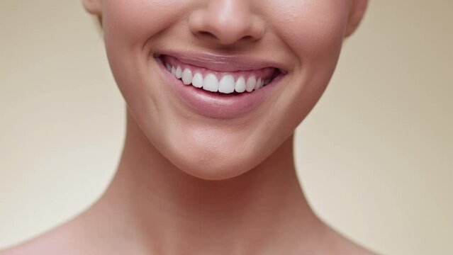 Professional dental care. Close up of woman smiling to camera, demonstrating perfect smile with healthy white teeth