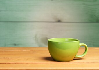 Green classic ceramic mug on table