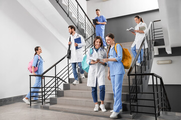 Medical students wearing uniforms on staircase in college