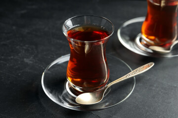 Glasses with traditional Turkish tea on black table, closeup