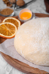 Fresh dough and ingredients on white table, closeup