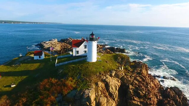 Aerial pan around in Maine lighthouse with stunning view of ocean waves